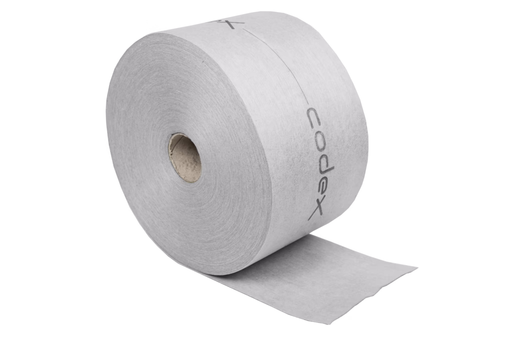 codex_Dummy_DB 140 Slim_2020-03 Close-up van een grote grijze toiletrol met een zichtbare kartonnen kern en een gedeelte van het vel losgerold; het papier toont een zwak gedrukt logo langs de buitenrand.